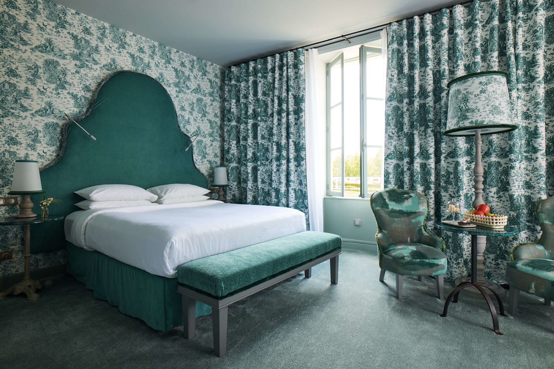 A Bedroom With A Bed And A Bench