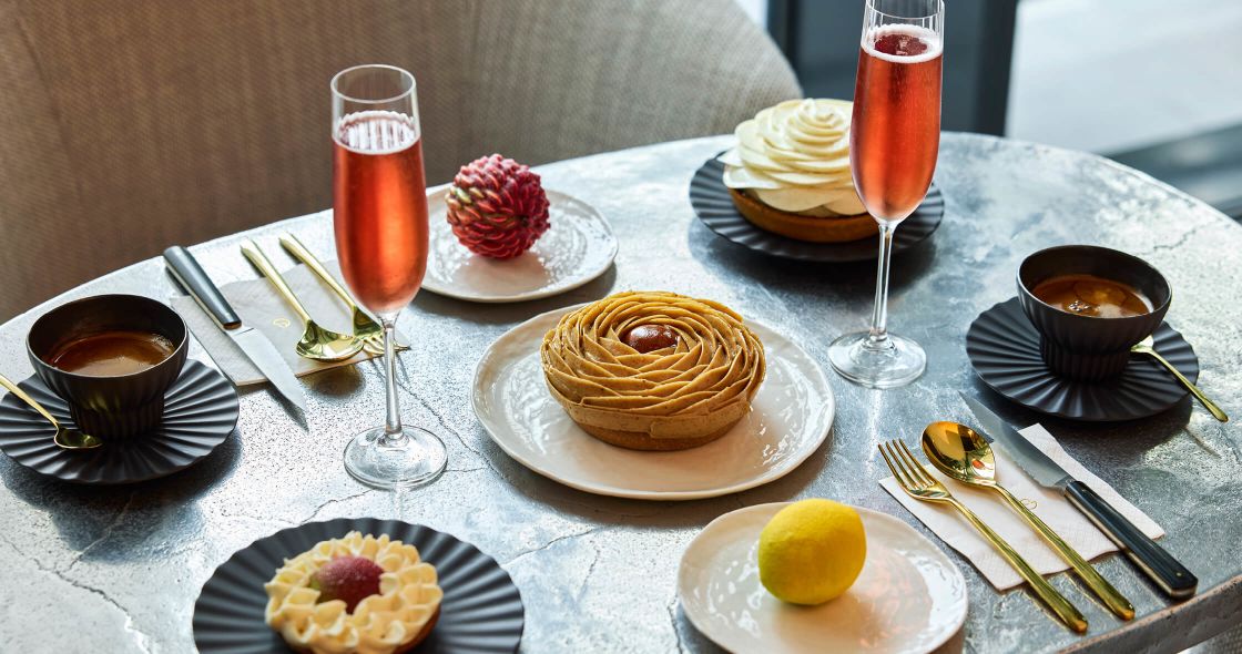 A Table With Plates Of Food And Drinks On It
