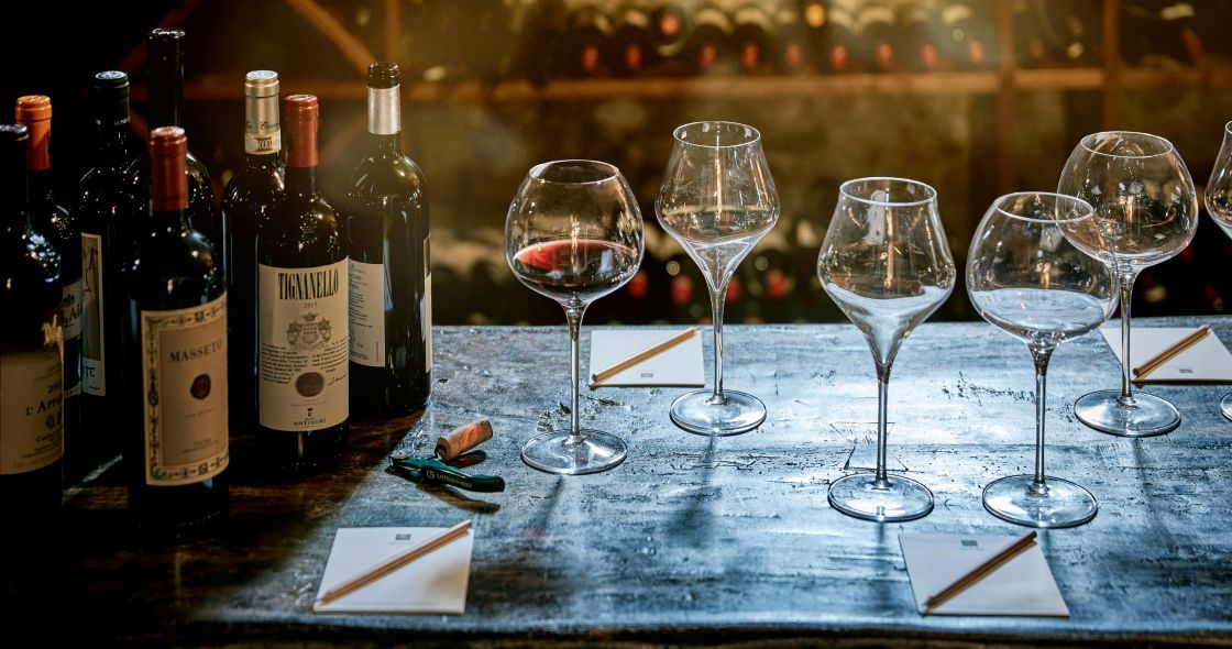 Wine Glasses And Bottles On A Table