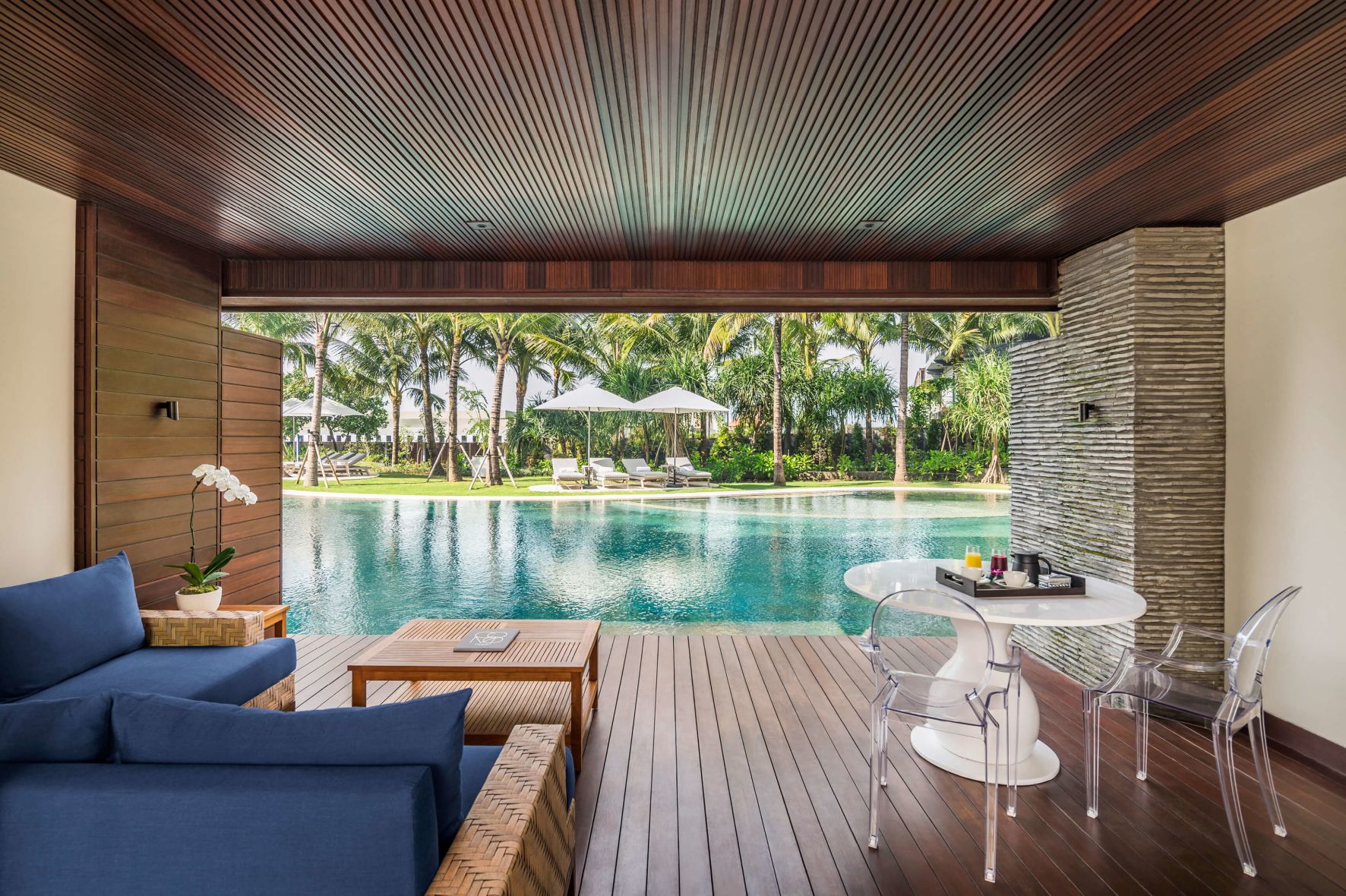 A Room With A Pool And Chairs