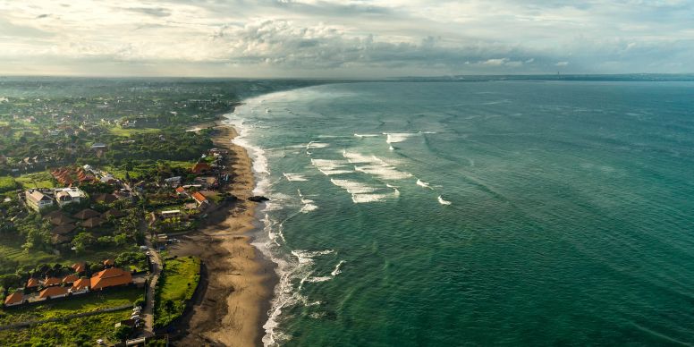 A Beach With Houses And Trees